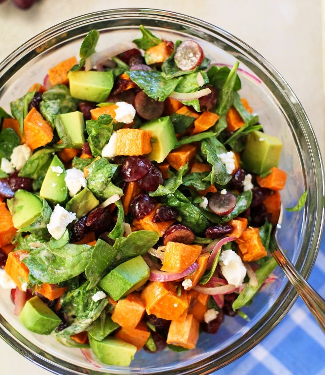 Roasted Sweet Potato Salad with Spinach, grapes, avocado, feta cheese and more! This hearty, healthy salad recipe is both light and filling! Make it for your guests for a crowd-pleasing side dish, or just add your favorite animal protein to turn it into an entrée salad.