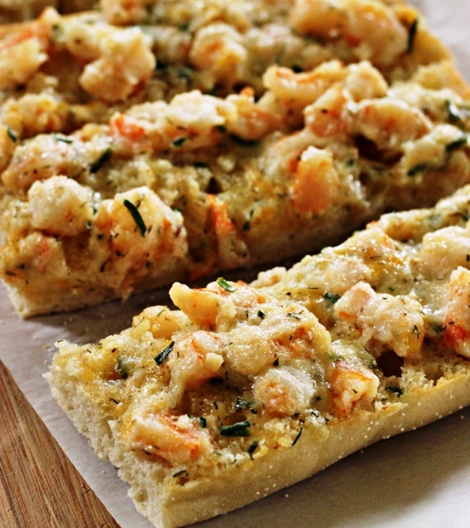 Chewy ciabatta bread is topped with tender chunks of shrimp, cheese and herbs then baked to perfection.