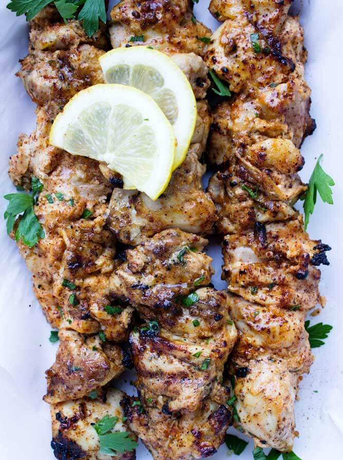 Juicy and tender yogurt marinated chicken kebabs with garlic, spices, lemon, and cilantro.