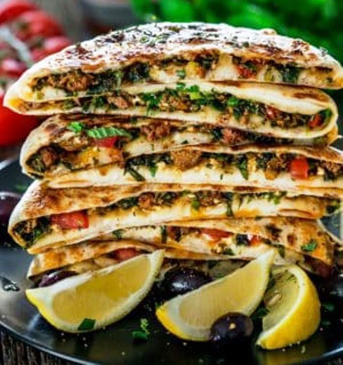 These Turkish Gozleme with Lamb are savoury homemade flatbreads made completely from scratch filled with ground lamb, spices, herbs and feta cheese. You won't be able to eat just one! They're incredibly delicious and full of great flavors!