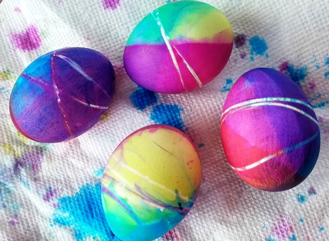 Using hard boiled eggs, wrap one or two rubberbands around them (it is a pain in the butt!) then put them in the cups. Wait 4-5 minutes then transfer it to another cup making different colors.