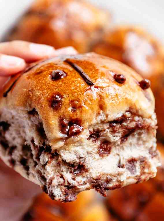 Fluffy and fragrant homemade hot cross buns filled with melted chocolate chips to please the kids as well as the adults! There’s just something about warm and fresh homemade breads! The best part? No proofing yeast! This recipe is so easy!