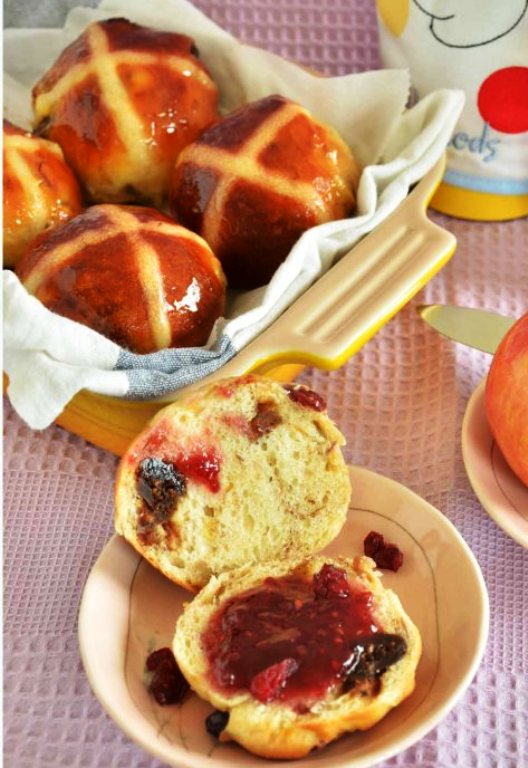 I am in my kitchen making my own hot cross buns.  I love how these buns are laced with cinnamon and orange zest, and all things nice like cranberries, figs, and raisins.