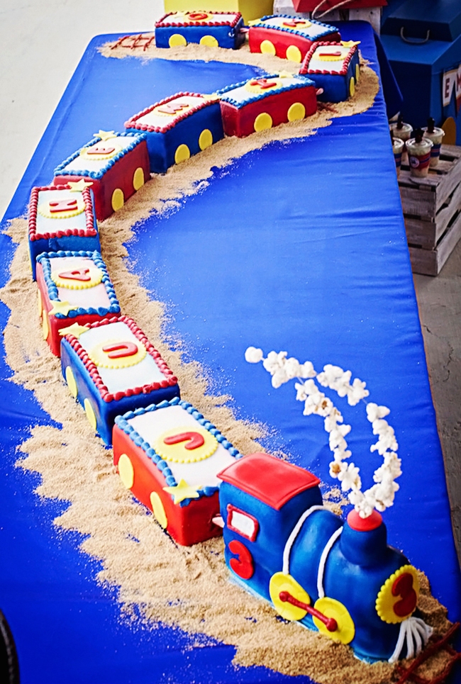 This fantastic train theme party was styled by Leslie Bost of ONE Happenings Weddings & Events for her son, Juan Emilio. Leslie used my train birthday party printable kit to decorate the party, and she made great use of all of the printable designs!