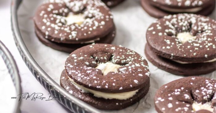Chocolate Linzer Cookies Recipe made with a soft, buttery chocolate dough, a hint of espresso, and filled with a rich cream cheese frosting.