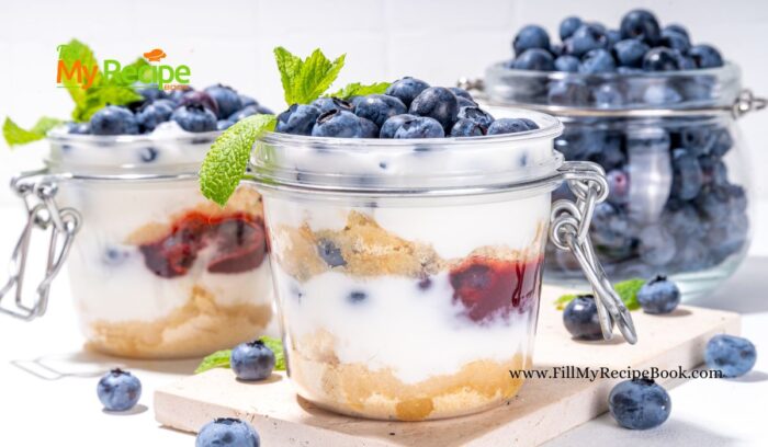 Layered Blueberry Parfait Dessert Recipe. A no-bake delight features crushed biscuits, honey infused cheesecake, and jam, all topped with fresh berries.
