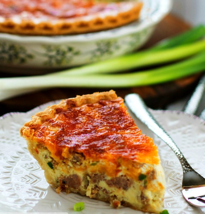 Easy Sausage Quiche is a spectacular savory pie that's ideal for serving at any meal. Breakfast sausage, green onion and lots of cheddar cheese smothered with a seasoned egg custard combine into a classic combination of flavors that always satisfy.