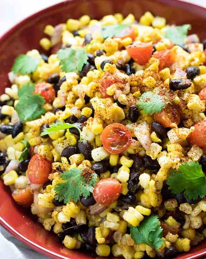 Mexican Corn and Black Bean Salad is a super easy and refreshing summer salad full of black beans, corn, and tomatoes! This black bean and corn salad comes together in a snap and has the most flavorful chili lime and garlic dressing!