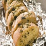 Homemade Garlic Braai Loaf recipe. Easy idea of a loaf, sliced stuffed with garlic, butter and parmesan cheese for starters, grilled in foil.