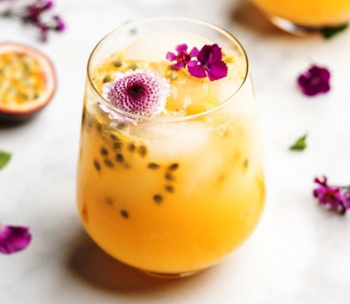 This Passion Fruit Gin Fizz Cocktail is bursting with flavor and incredibly simple to make! Passion fruit is the main star of the show in this gin based cocktail, with it’s heavy tropical flavors that lean very slightly tart.