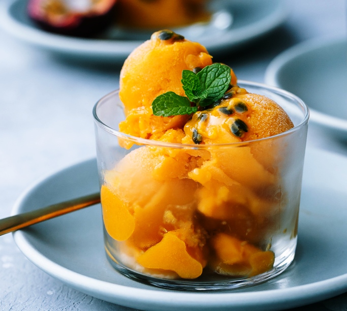 This Mango Sorbet recipe with fresh passion fruit is tropical, tangy and light- the most refreshing vegan summer treat that couldn’t be easier to prepare!