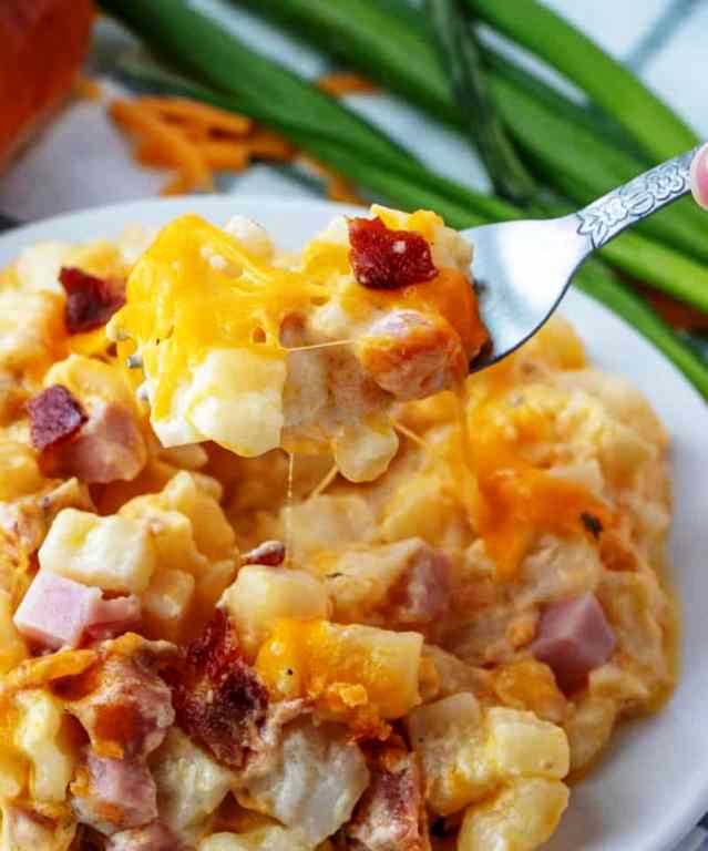Hearty, creamy and flavorful these Cheesy Potatoes are filled with bits of ham, crumbled bacon, loads of cheese and is bursting with flavor in each and every bite.