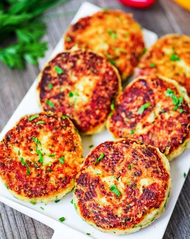 These Parmesan Mashed Potato Cakes are so addictive! A crunchy, cheesy crust is hiding the soft, velvety mashed potato filling. They make a perfect side dish or a filling vegetarian meal.