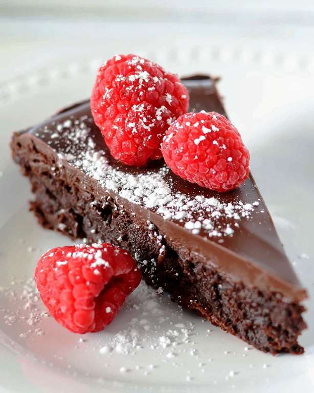 Simple, smooth, and fudgy Flourless Chocolate Cake is sure to get rave reviews. It’s a great cake to add to your favorite go-to desserts.