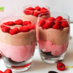 Chocolate Raspberry Cheesecake in a Glass recipe as a dessert. Easy layered whipped cream and cream cheese, cocoa with raspberries parfait.