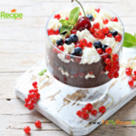 Christmas Cherry Trifle Bowl recipe idea. Easy family fancy dessert, layered sponge cake and cream with blueberries and cherries for pudding.