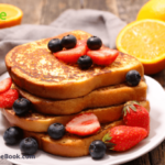 French Toast with Blueberries and Strawberries. A special occasion breakfast to be made adding berries and honey.