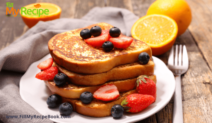 strawberries and blueberries with a plate of french toast