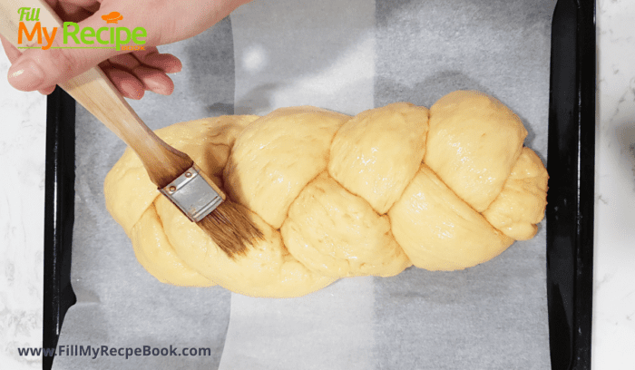 washing the braided loaf with egg mix to bake