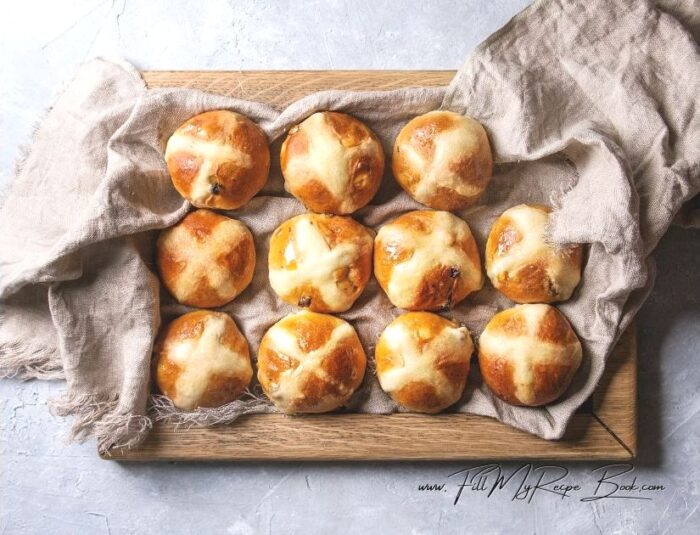 Make the paste for the crosses and then cross the buns read to go into the oven.