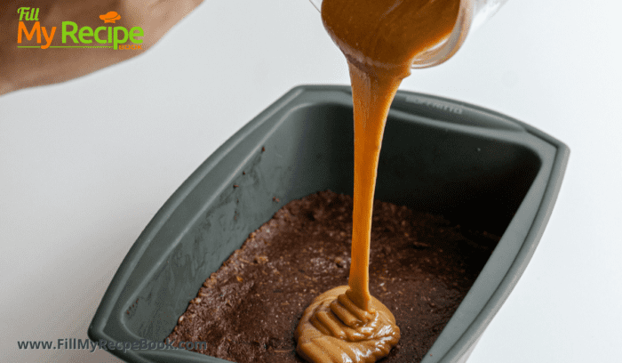 Brownies been pressed into a bowl and caramel poured on top of them to fridgerate