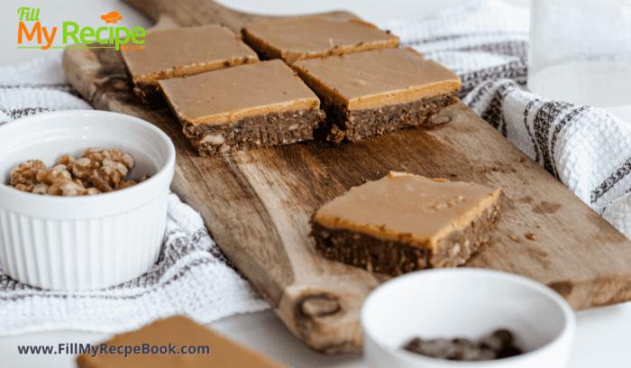 On a bread board some sliced cold brownies with caramel