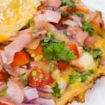 Cheese and Bacon Omelet recipe idea. Easy egg breakfast or brunch meal filled with cheese bacon or ham and bell peppers, onions.