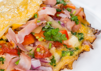 Cheese and Bacon Omelet recipe idea. Easy egg breakfast or brunch meal filled with cheese bacon or ham and bell peppers, onions.