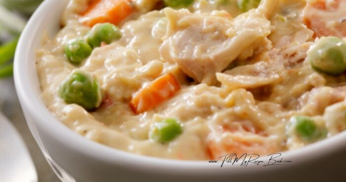 Adding the chicken and sauce to the rice and vegetables, then serve in a bowl for a delicious quick family dinner.