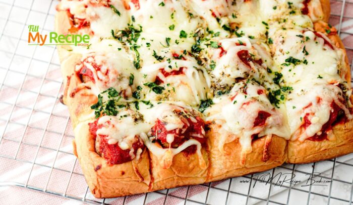 Easy Pull Apart Meatball Sliders recipe. Use Hawaiian rolls, cheese, and drizzle with garlic, Italian herbs in butter before baking in oven.