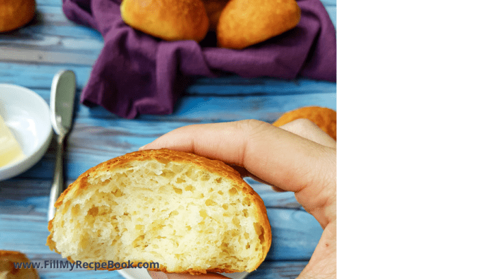 A baked lunch roll cut in half 