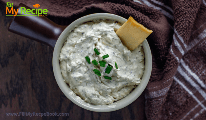 crackers and green onion dip in a bowl with snacks