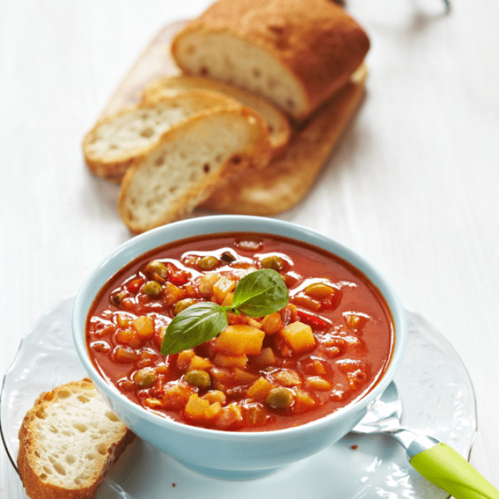 Tasty Minestrone Soup recipe. Homemade for cold days with bacon and pasta pieces served with some cut pieces of bread or fresh buns.