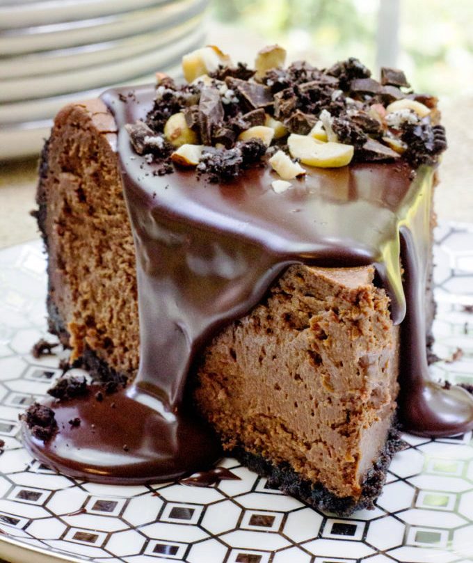Rich Chocolate Hazelnut Cheesecake made with Chocmeister Milk Chocolatey Hazelnut Spread, a chocolate cookie crust and a thick, glossy chocolate ganache.