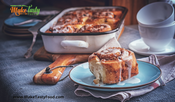 a full casserole dish with baked cinnamon rolls and a plated roll for tea
