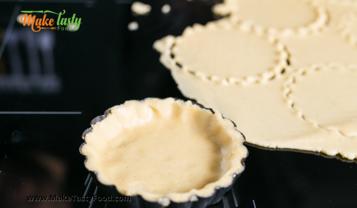 shortbread crust dough cut and pressed into tartlet pans.