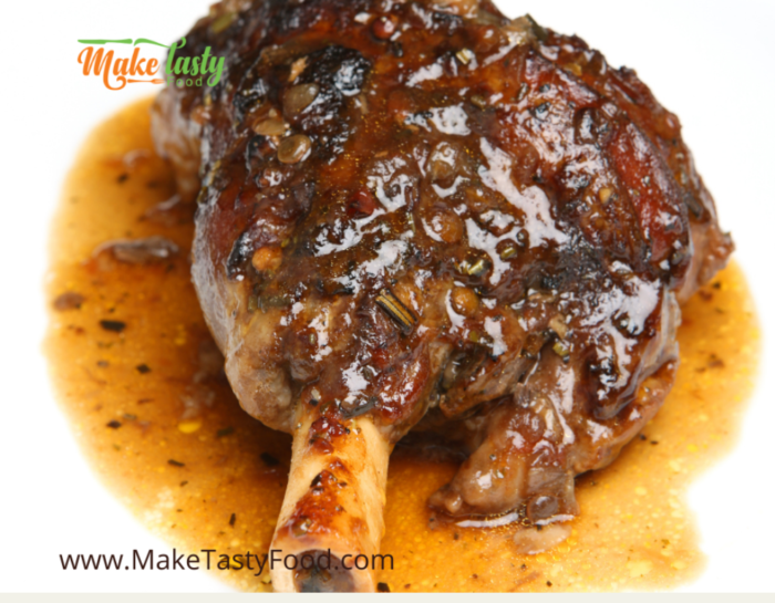 a well done lamb shank with spices and gravy