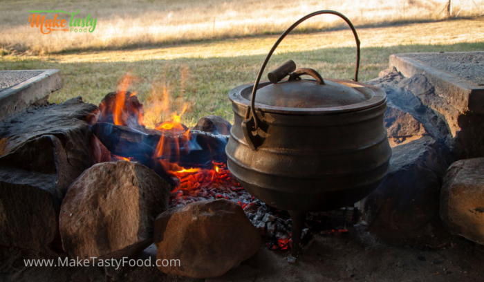 Filling Lamb Shank Potjie recipe. A South African family pot around the fire with lamb shank and potatoes. Simmering on coals while chatting.