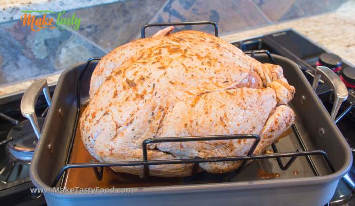 preparing the turkey with herbs and butter for roasting
