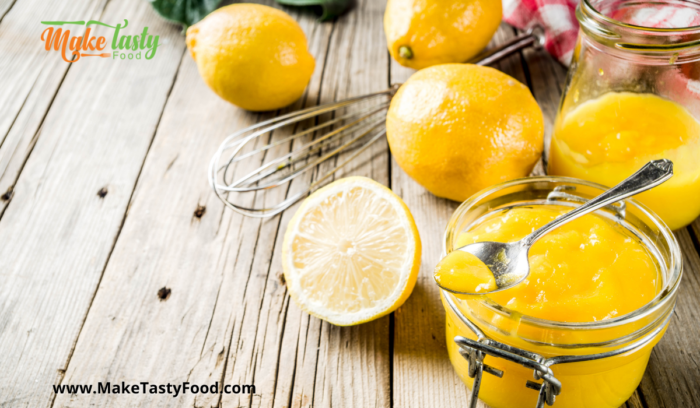 homemade lemon curd with some cut lemon lemons