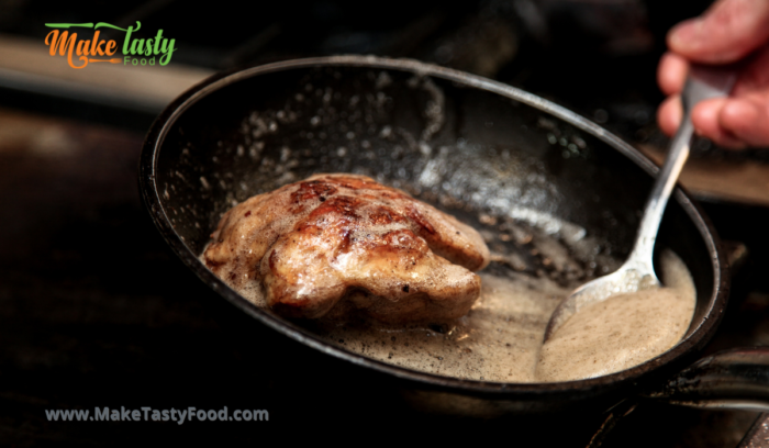 scooping the steak with butter and herbs before serving
