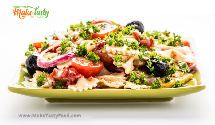 Tossed pasta salad and dressing dressed with mayonnaise and mustard and parsley