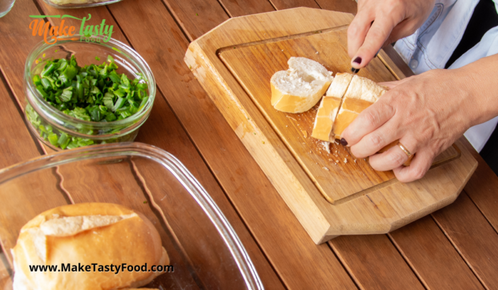 cutting up the bread in slices to serve with the soup