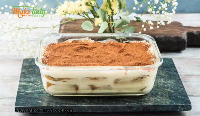 a rectangular tiramisu tart dusted with cocoa powder chilled and to serve.