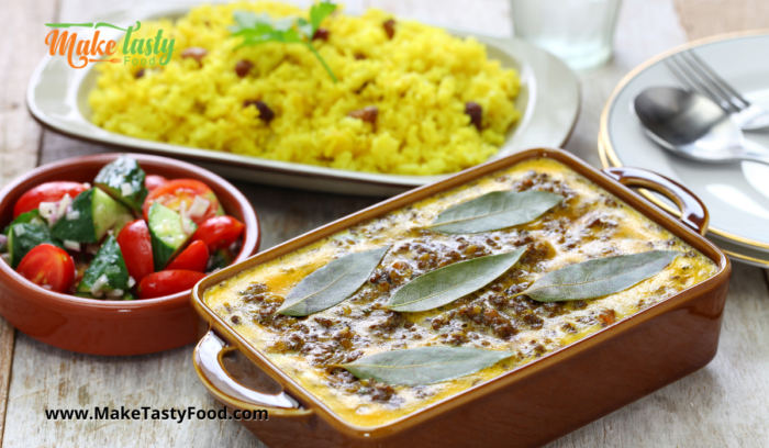 Traditional Bobotie and Yellow Rice baked in a casserole dish in the oven

