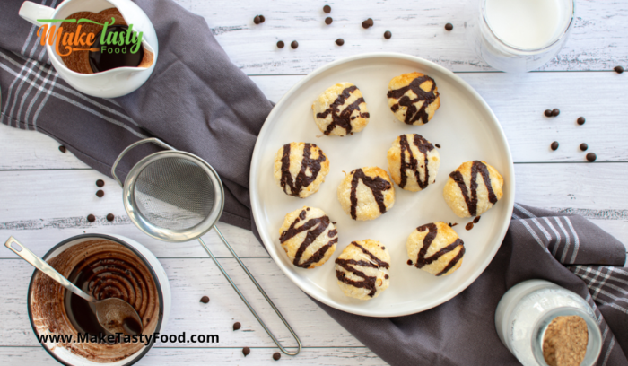 a plate of coconut macaroons served with chocolate