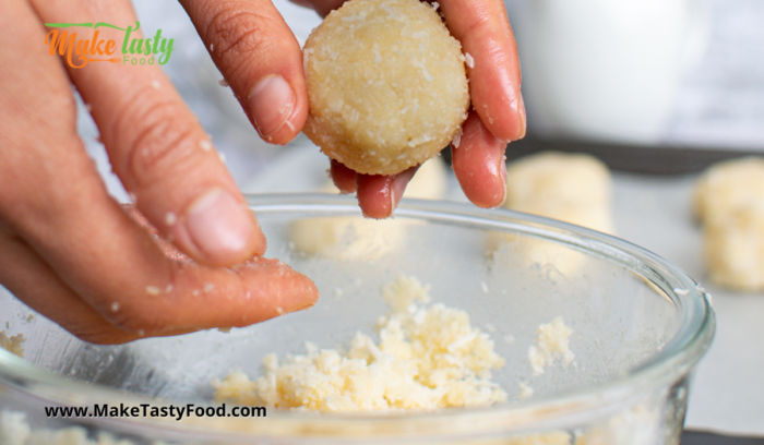 using your hands rounding coconut macaroons for baking