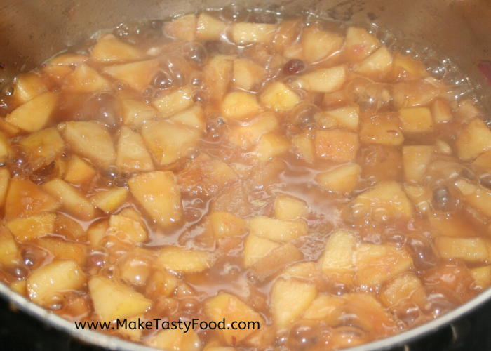cut up pears cooking in sauce in a pot