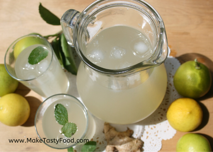 Jug of ginger beer and glasses with ice and mint