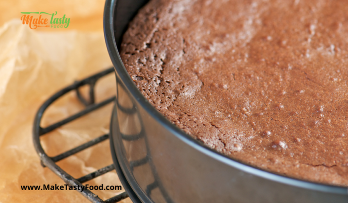 make a perfect chocolate cake baked and cooling in a pan on the cooling rack

